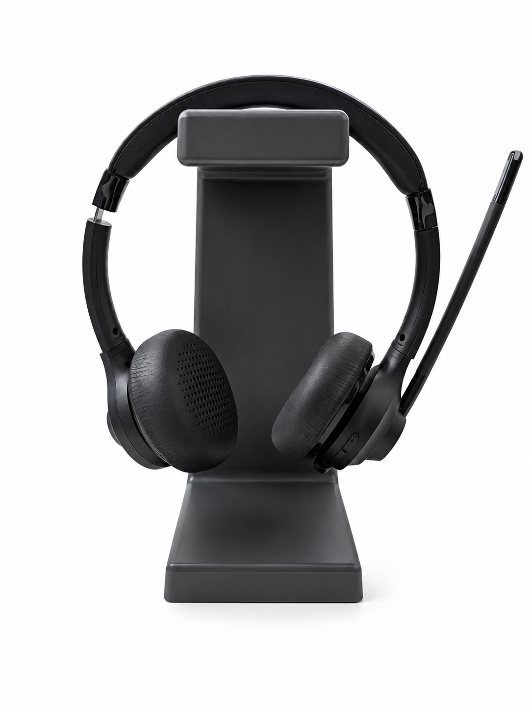 Black headphones on a stand against a white background