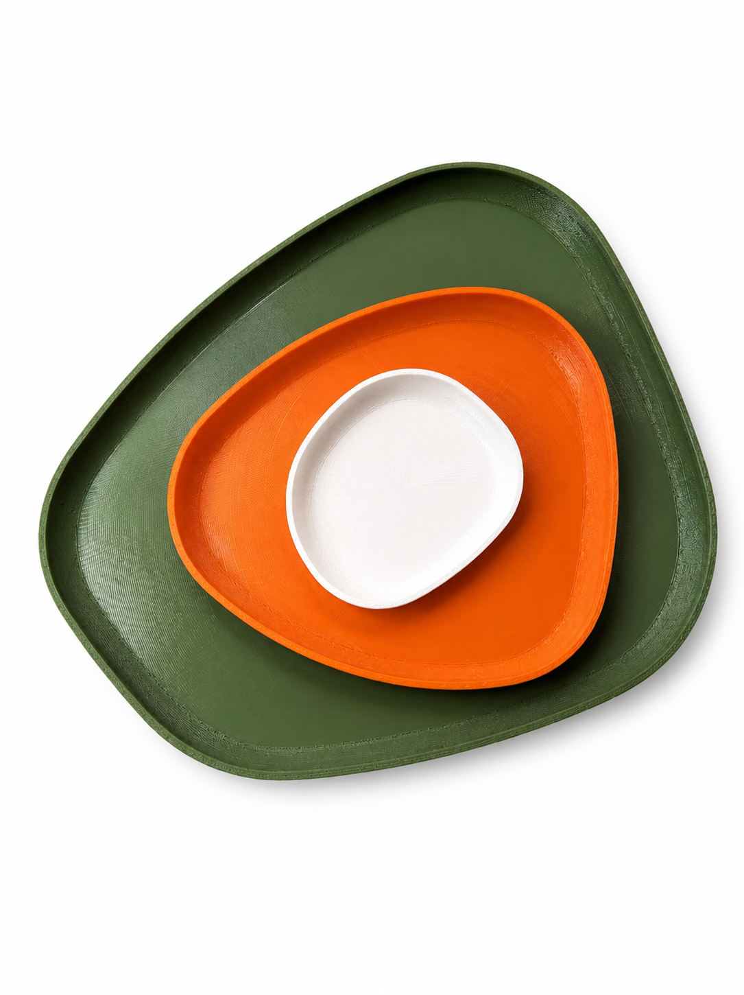Green and orange plate with a white bowl on a white background